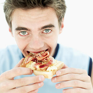 American_Teenage_Boy_Eating_Bacon