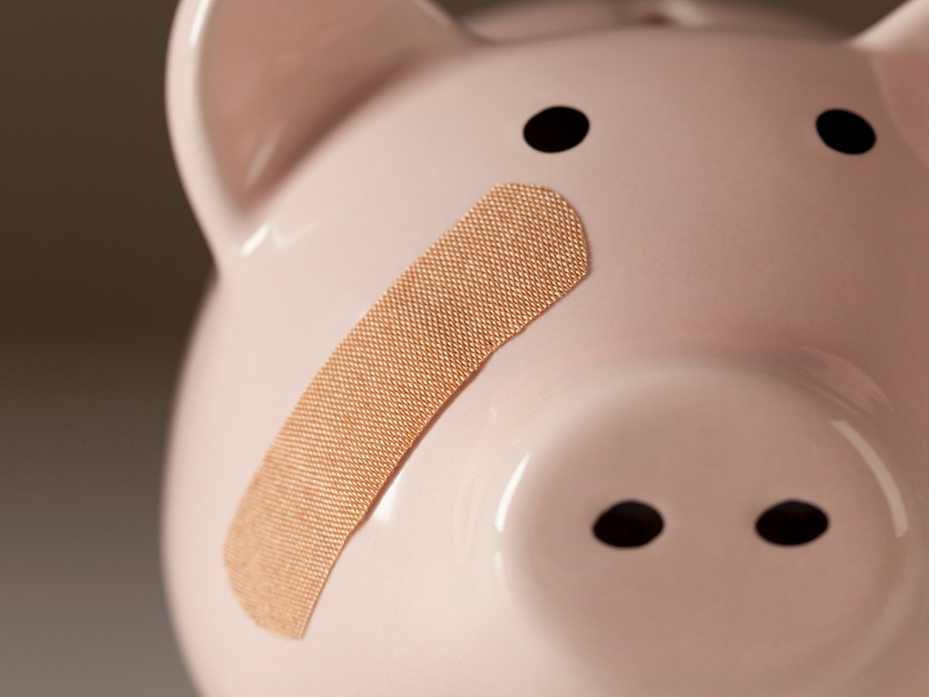 Piggy bank with a bandaid
