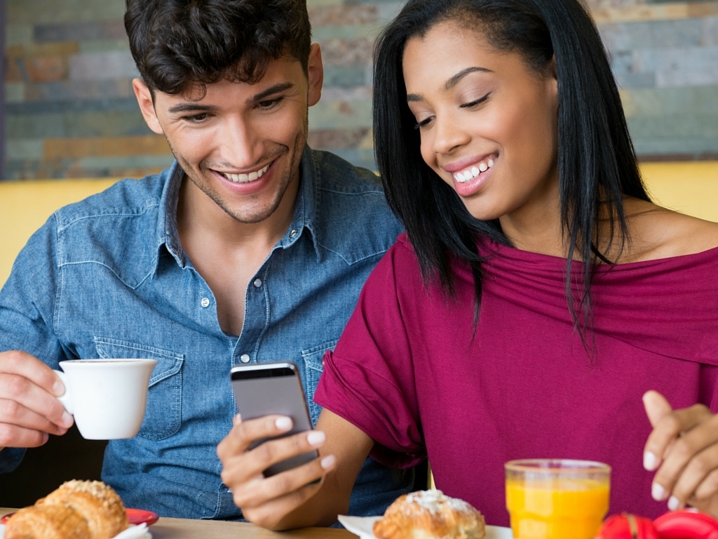 Young adult customers eating breakfast at a fast casual restaurant